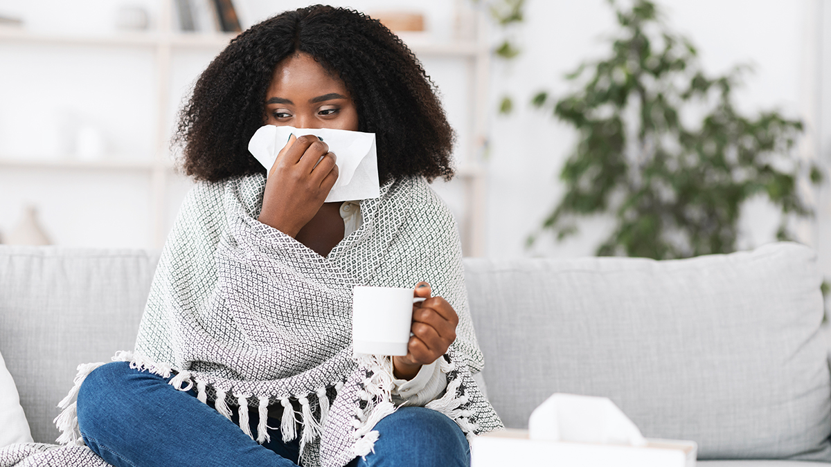 Person resting and using supportive care for common cold symptoms