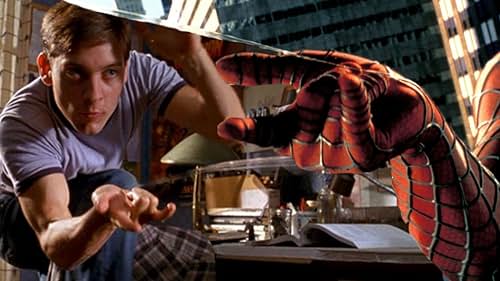 Tobey Maguire as Spider-Man in his red and blue suit, swinging through a cityscape